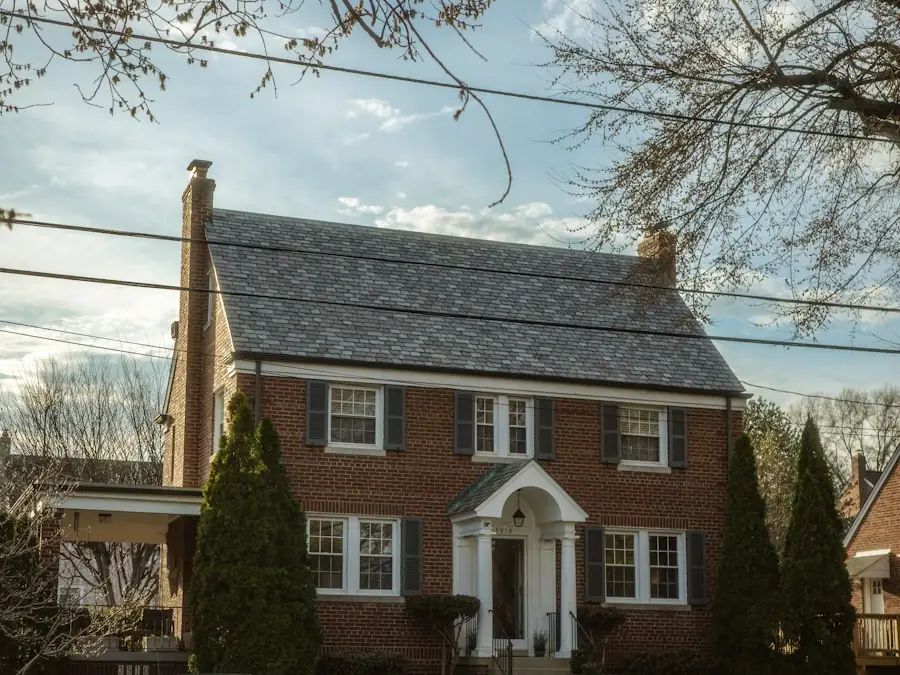 An ordinary brick colonial house on a suburban street